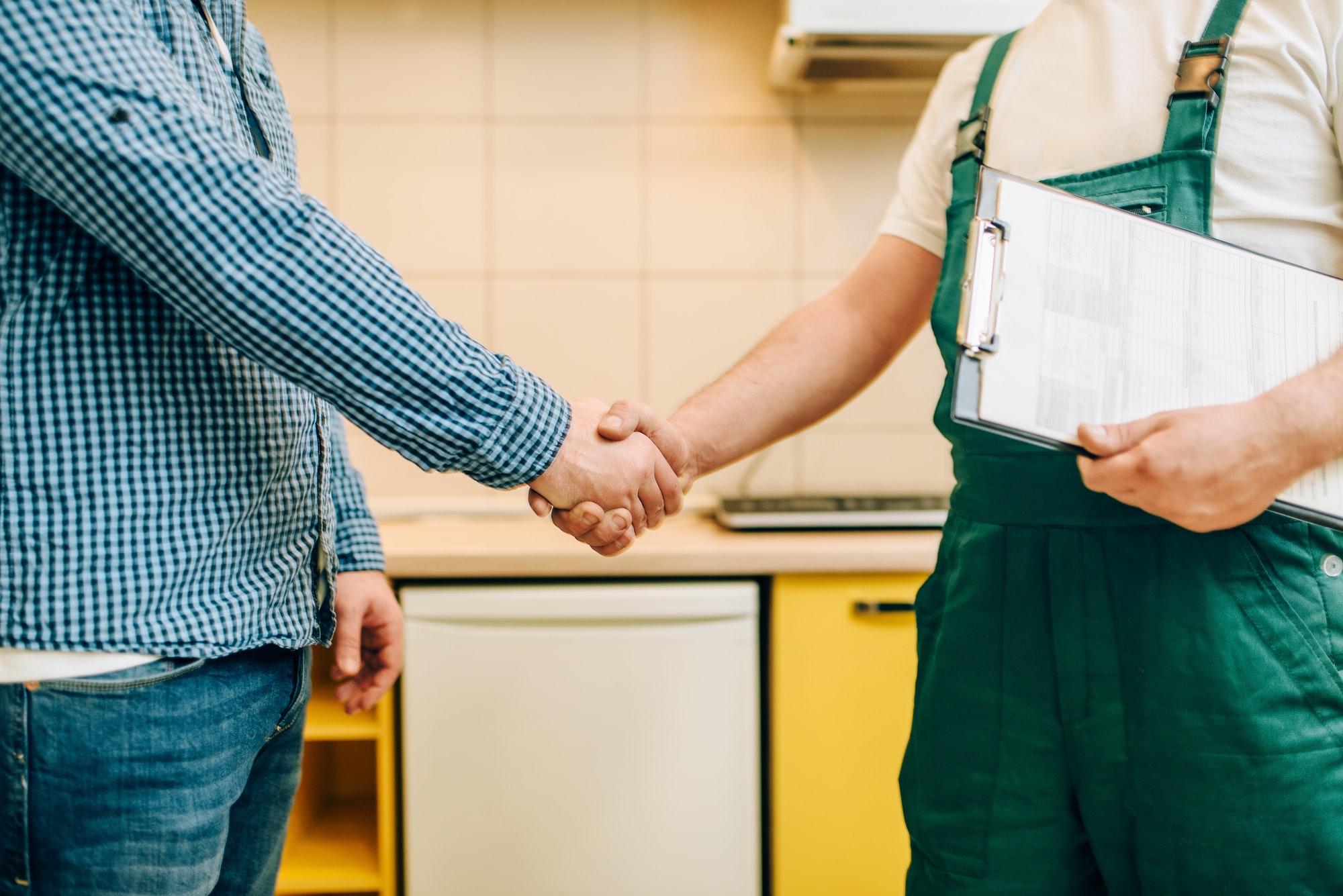 Repairman and customer shake hands, handyman
